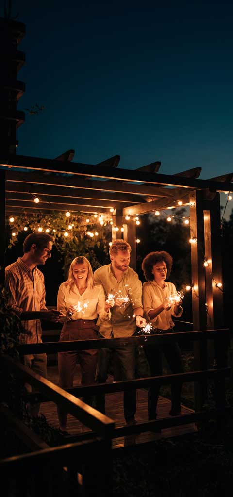 People on a deck at night at Jet Stream Waller RV Park in Houston Texas