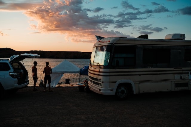 rv trailer parked by a body of water